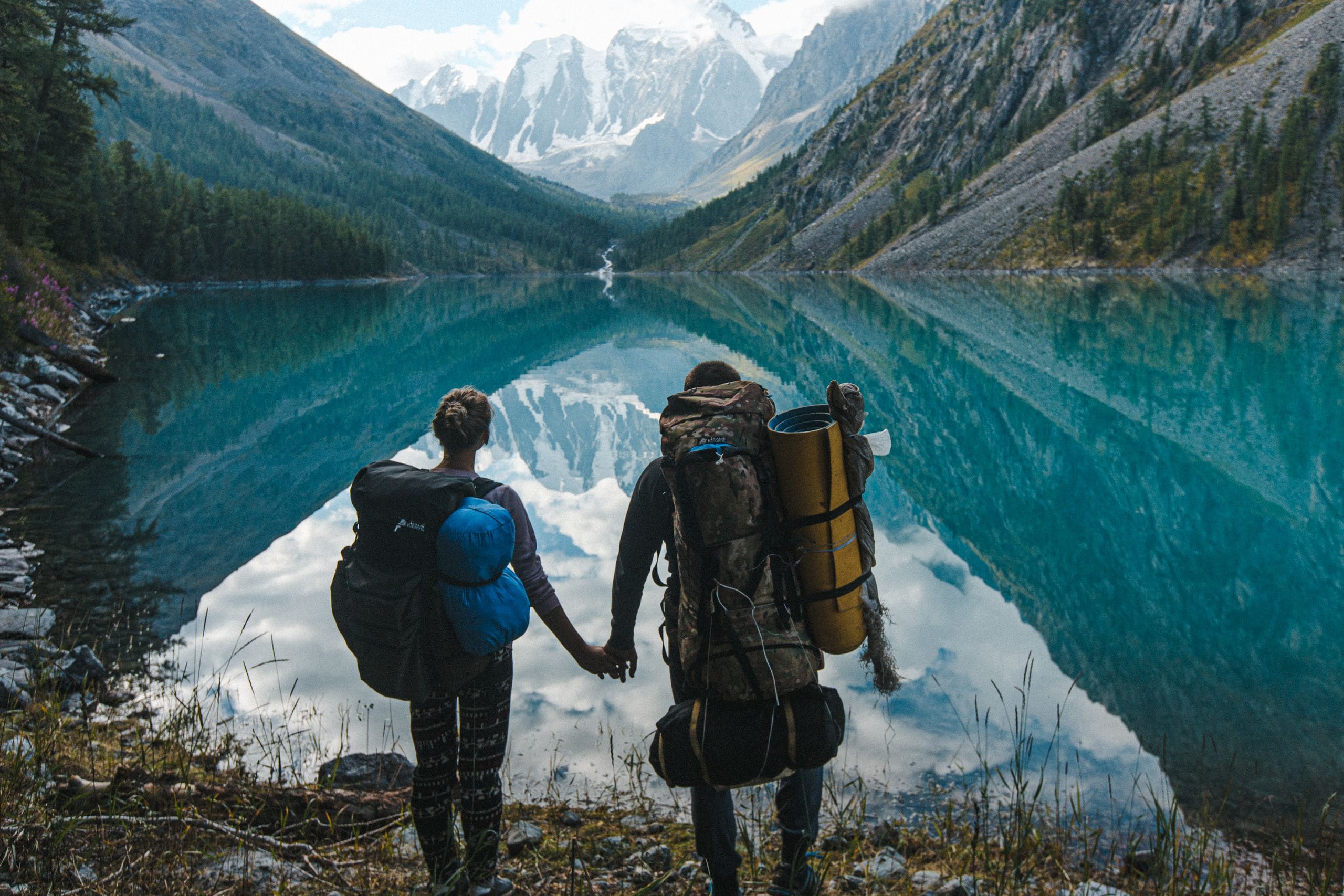 Hikers overlooking a turquoise lake in the Rocky Mountains near Calgary
